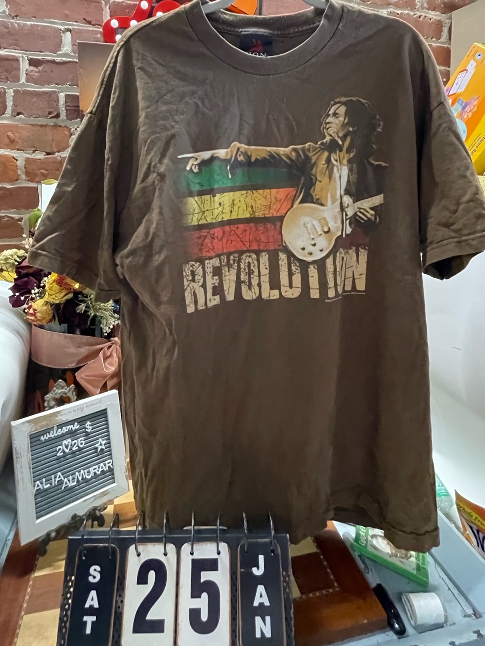 Bob Marley graphic with Rasta-colored stripes and "REVOLUTION"